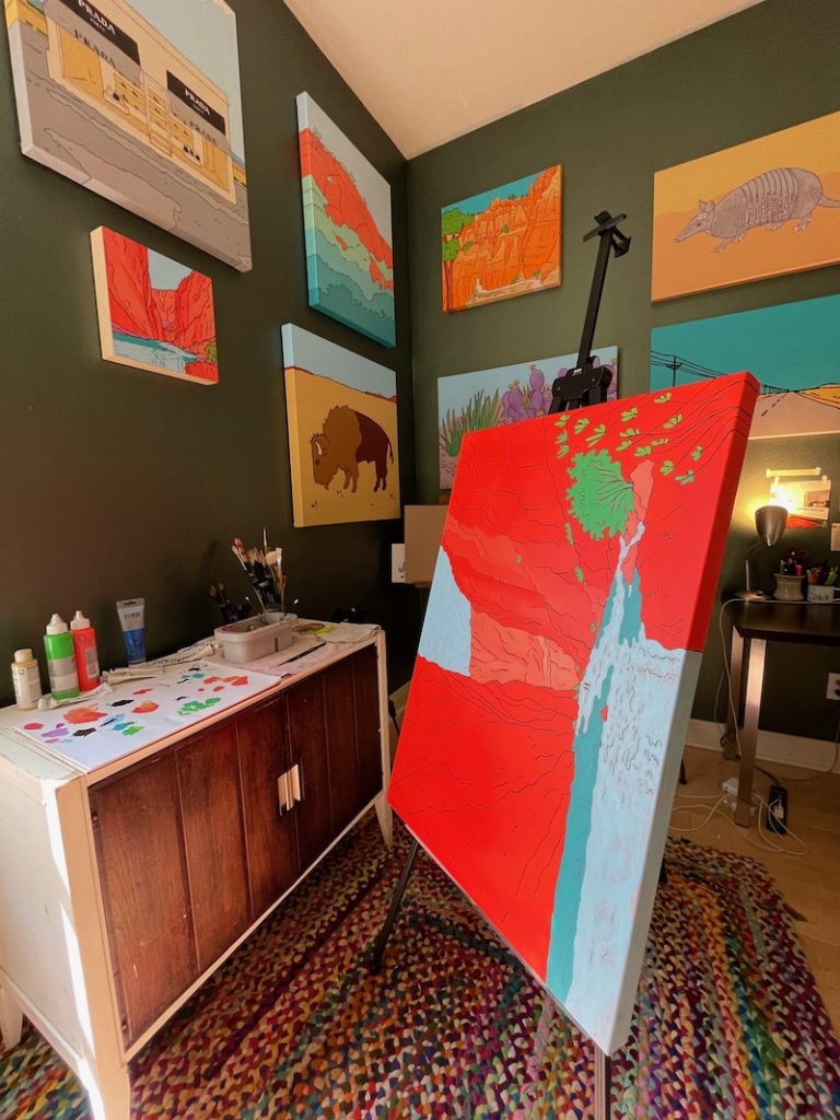 Art studio with painting on easel.
