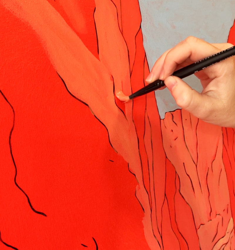 Cara painting a bright orange color.