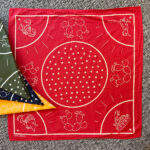 Cotton Bandana with white line art showing a different animal in each corner and stars in the center